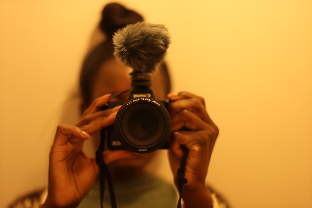 a woman taking a picture of herself with a camera