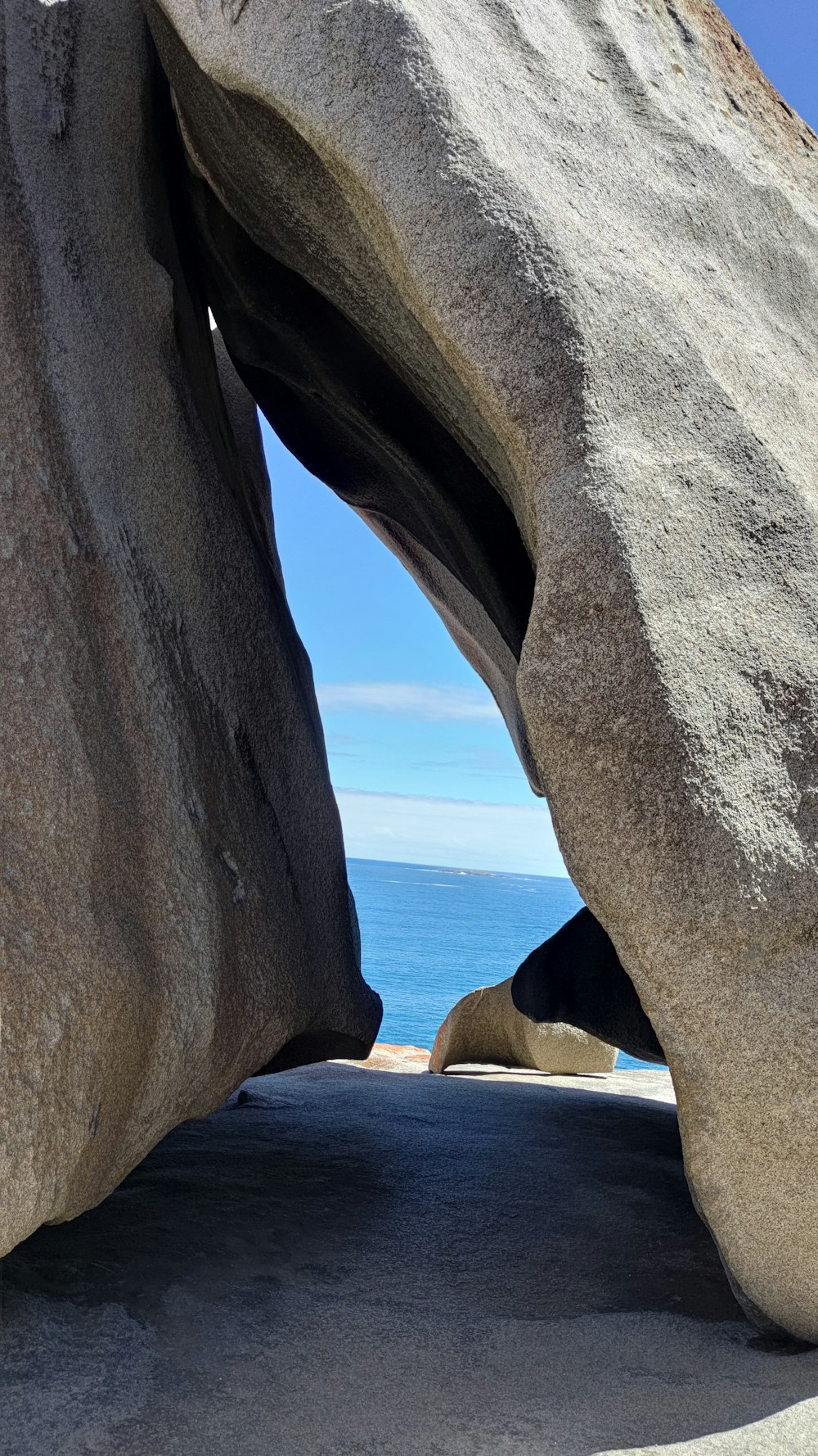 a large rock formation with a view of the ocean