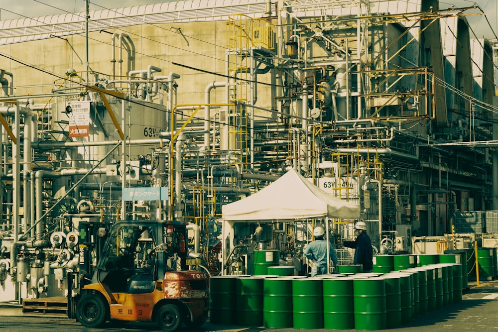 a man standing in front of a machine in a factory