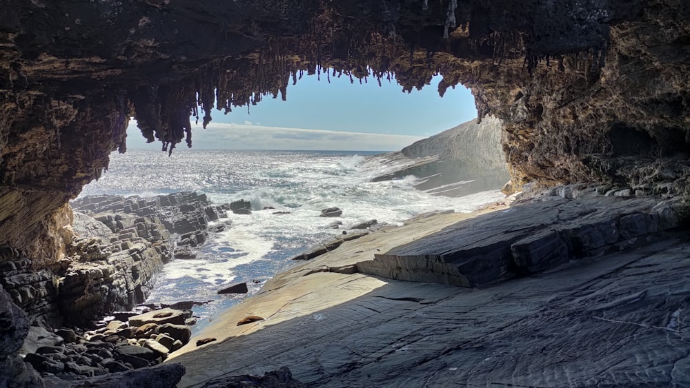 a view of the ocean from inside a cave