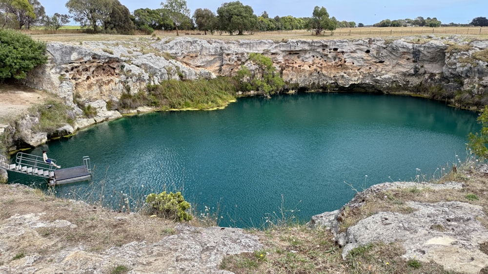 a boat is docked in a deep blue lake