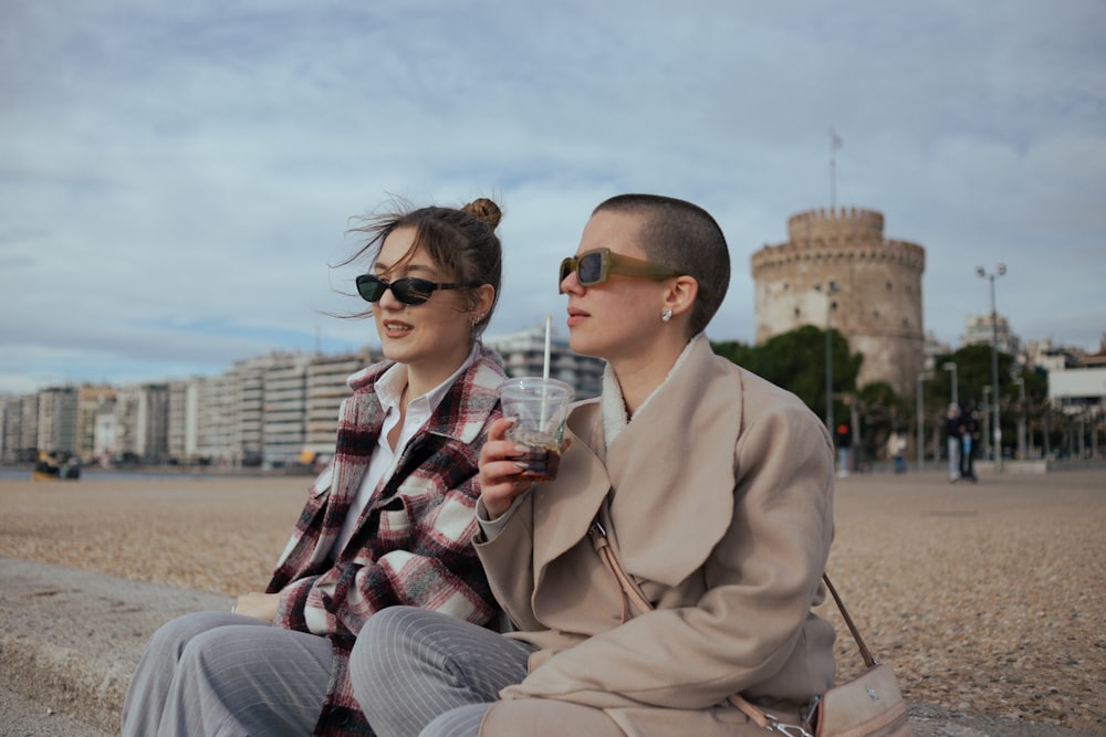 a man and a woman sitting on a beach