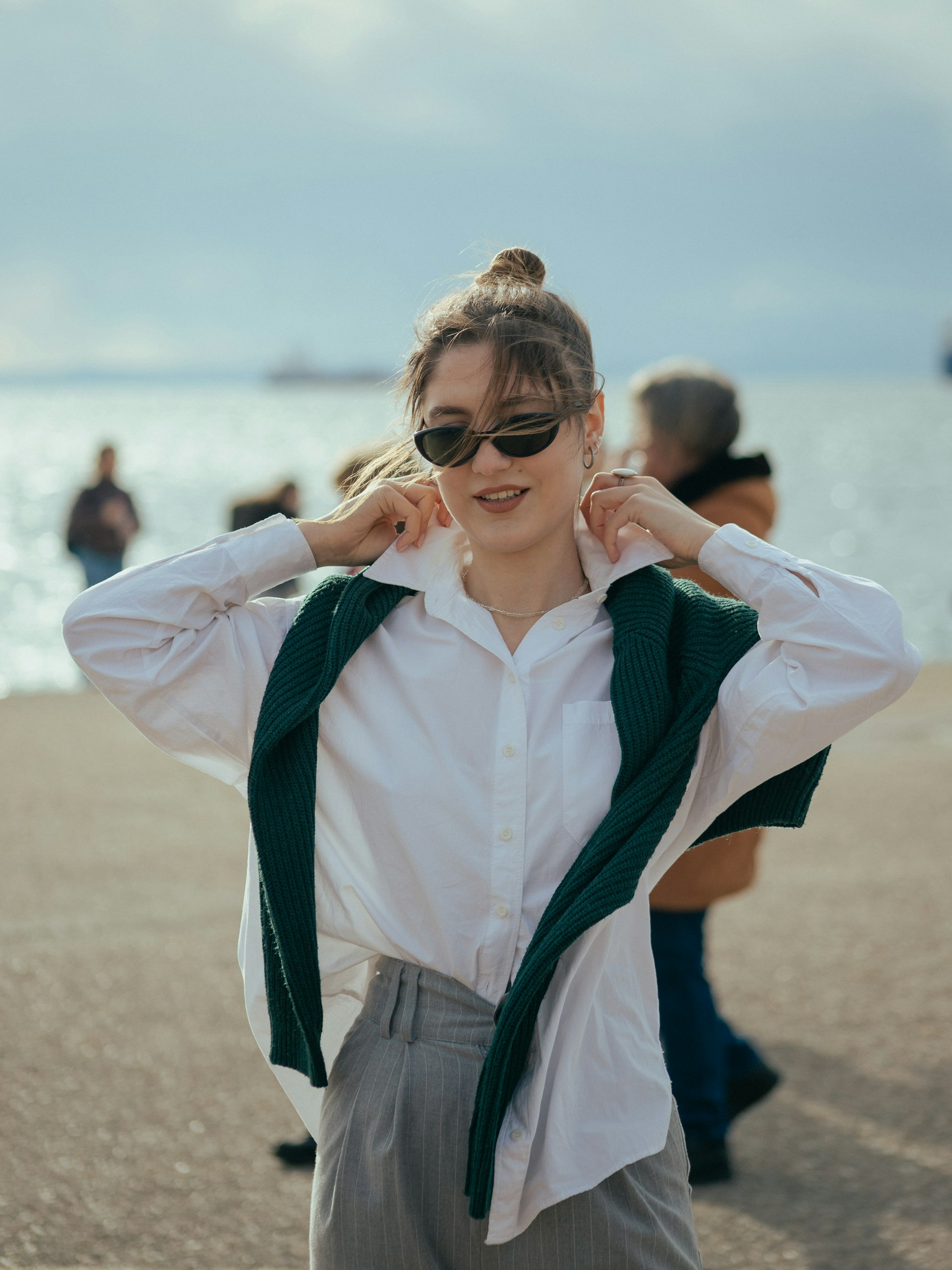 a woman in a white shirt and green scarf