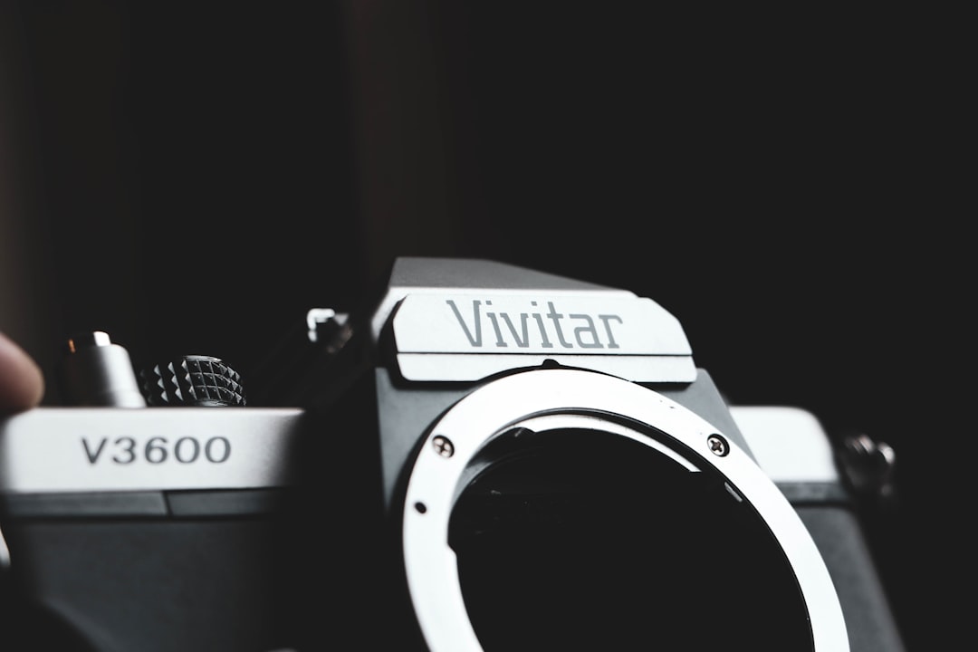 a close up of a person holding a camera, Vintage camera shell