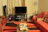 Cozy and stylish living room featuring custom wood furniture with subtle orange accents.