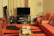 Cozy and stylish living room featuring custom wood furniture with subtle orange accents.