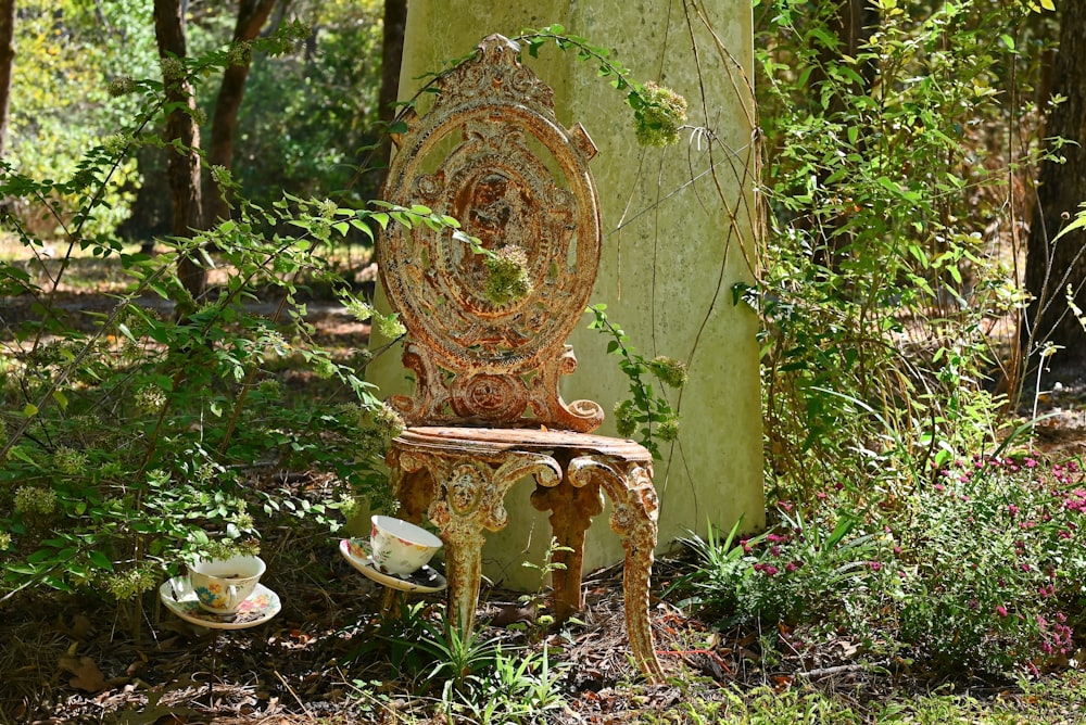 an old chair and table in the woods