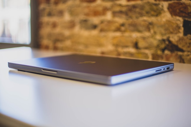 Sleek high-end laptop with brushed metal finish on a minimalist desk.