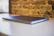 A close-up photo of a sleek aluminum whiteboard with a clean white background, highlighting its smooth surface and sturdy frame.