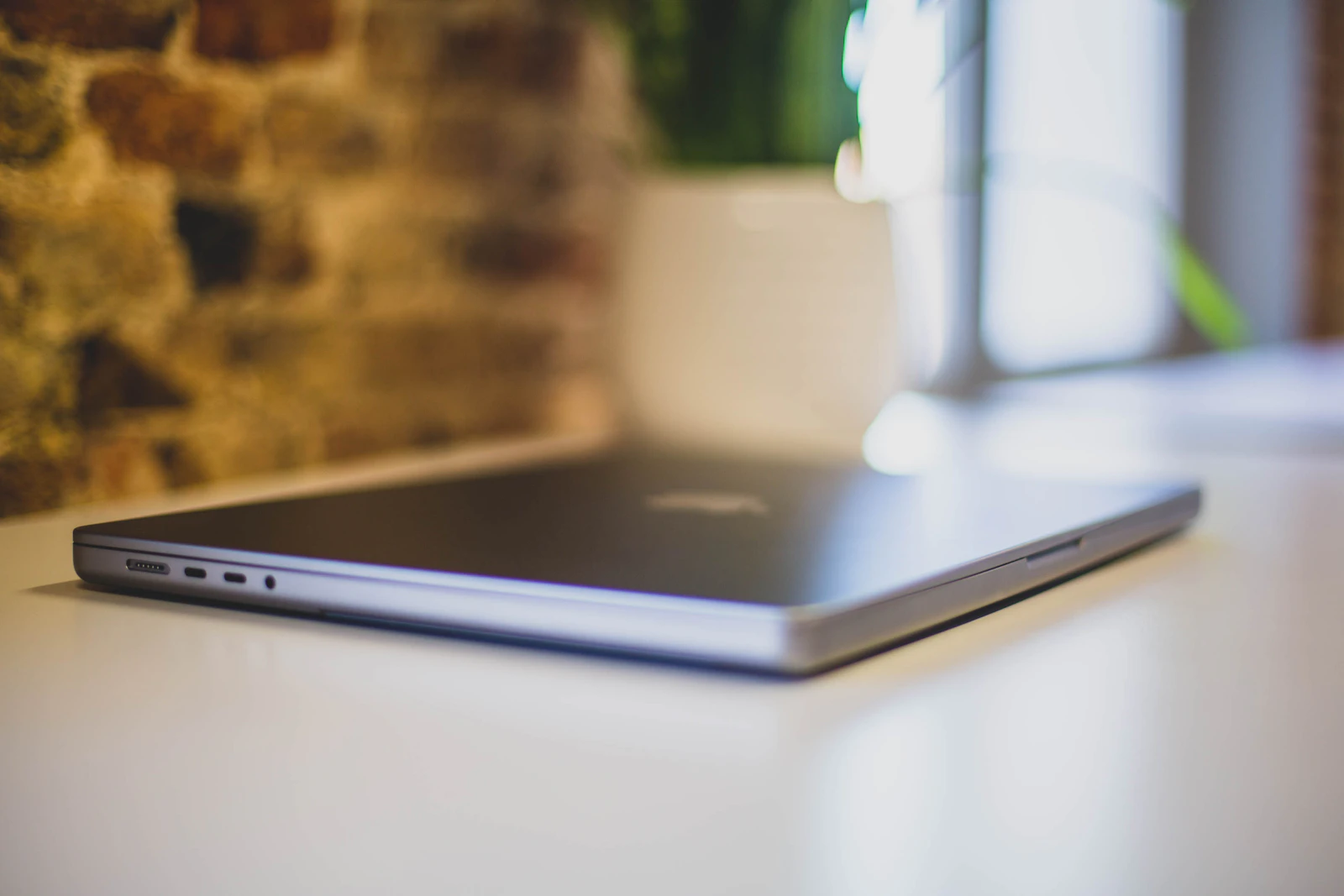 Closed laptop side showing two USB-C Thunderbolt ports next to MagSafe