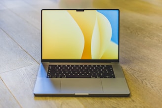 A sleek laptop screen displaying a vibrant, modern website with yellow and black accents.