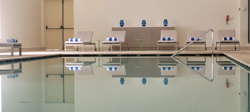 A stylish poolside setup featuring elegant accessories and maintenance products.