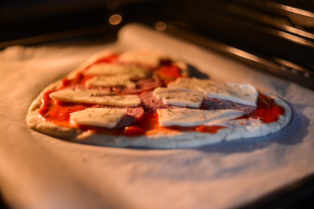 a pizza sitting on top of a pan covered in sauce