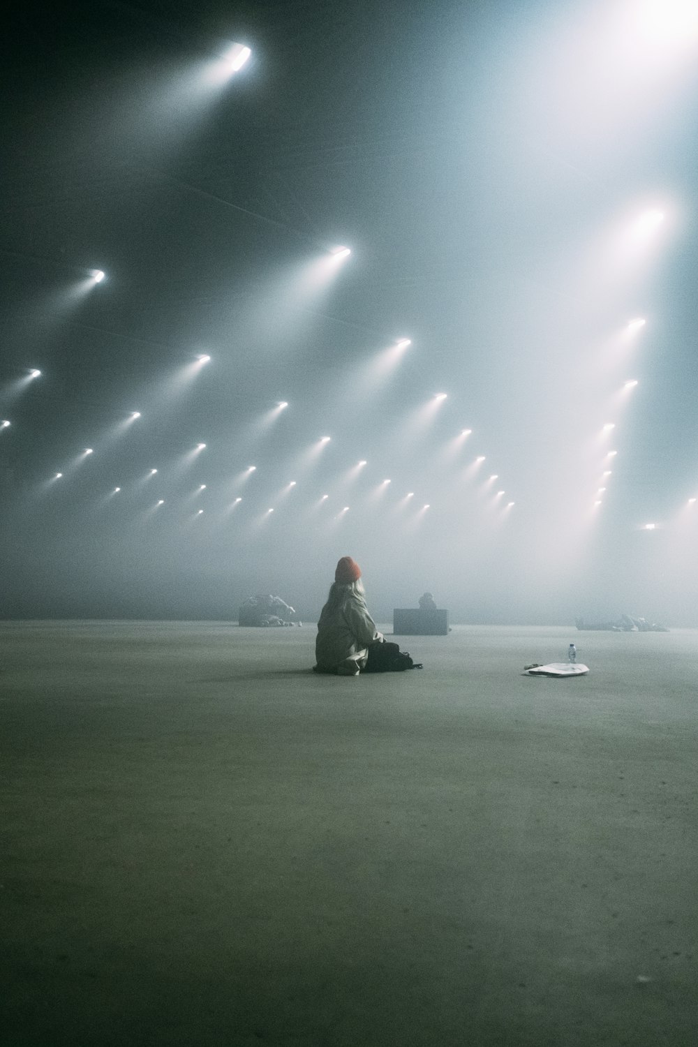 a person sitting on the ground in a dark room