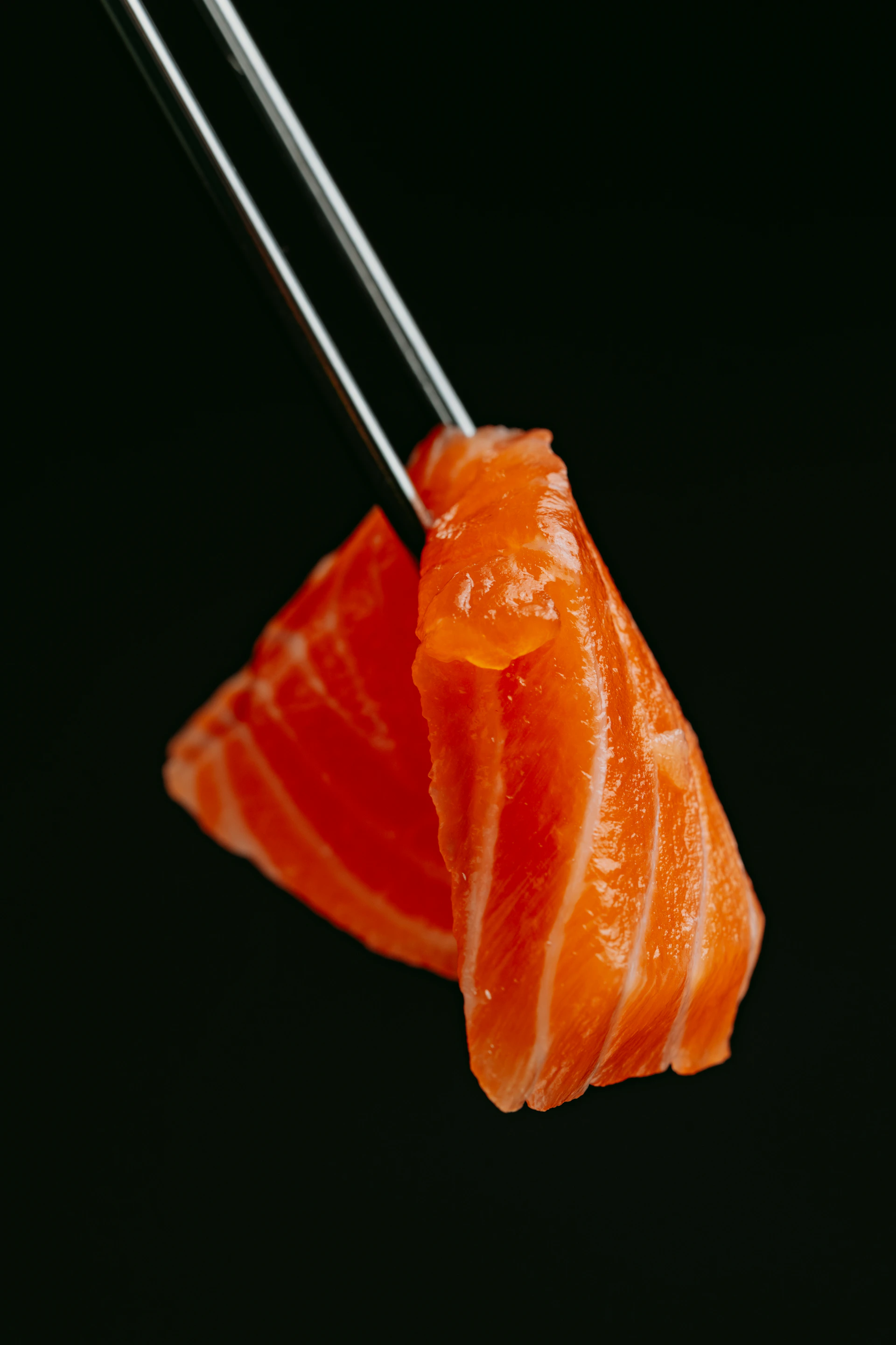 a piece of sushi with chopsticks sticking out of it