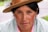 a woman wearing a brown hat and a pink shirt