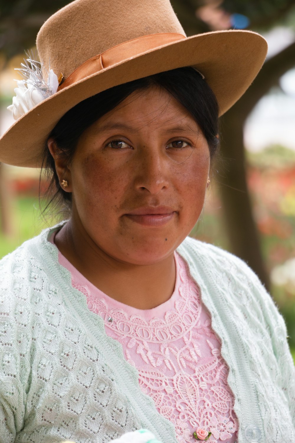 a woman wearing a hat and a sweater