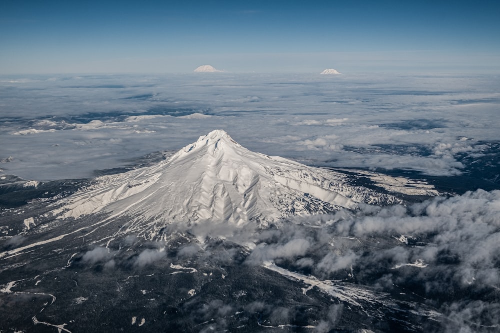 a view of a snow covered mountain from an airplane