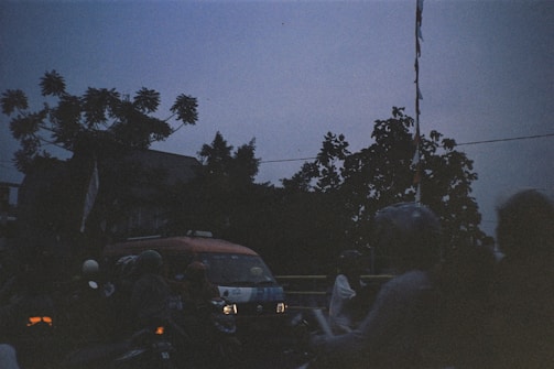 A vibrant scene of motocamping with friends at sunset in the woods.