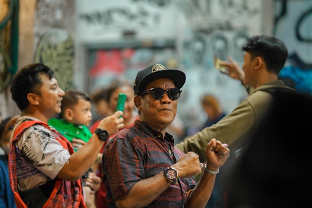 A vibrant urban street scene with young people wearing ultrakin streetwear, showcasing caps, t-shirts, and sneakers.