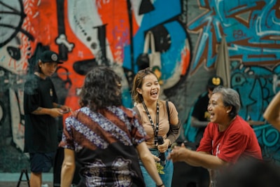 Behind-the-scenes shot of bigg britt vibing with her crew during a video shoot, laughter and energy filling the frame.