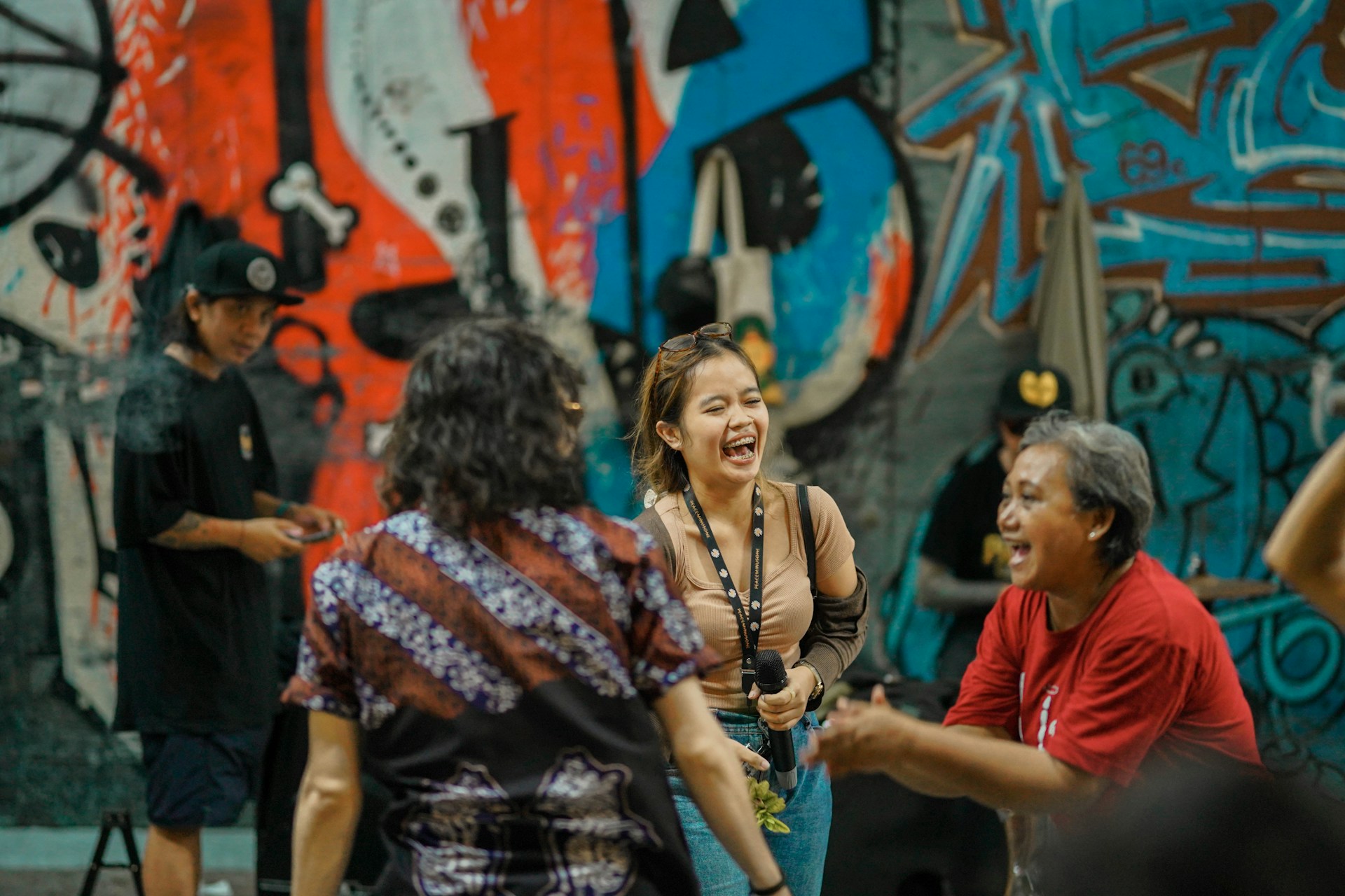 A lively scene of a small group laughing with a local artist in front of vibrant Berlin street art, capturing the city's edgy cultural spirit.
