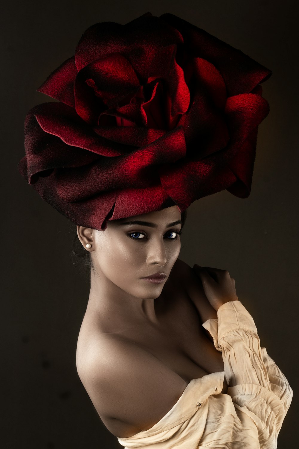 a mannequin with a red rose on it's head
