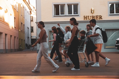 Young people laughing and walking on the city streets wearing fresh, modern espadrilles from Joppa.