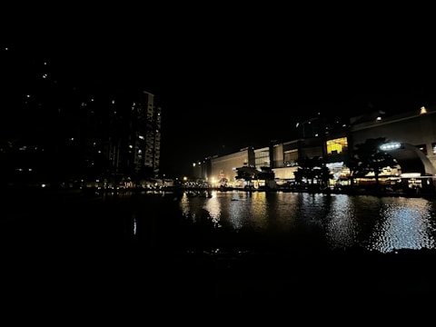 Night view of a well-lit mixed-use real estate development.