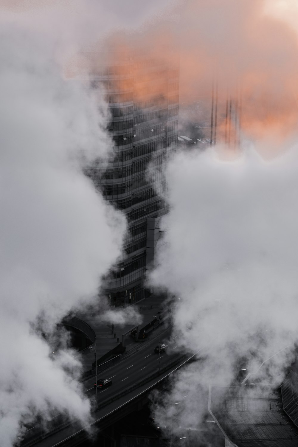 a tall building with a lot of smoke coming out of it