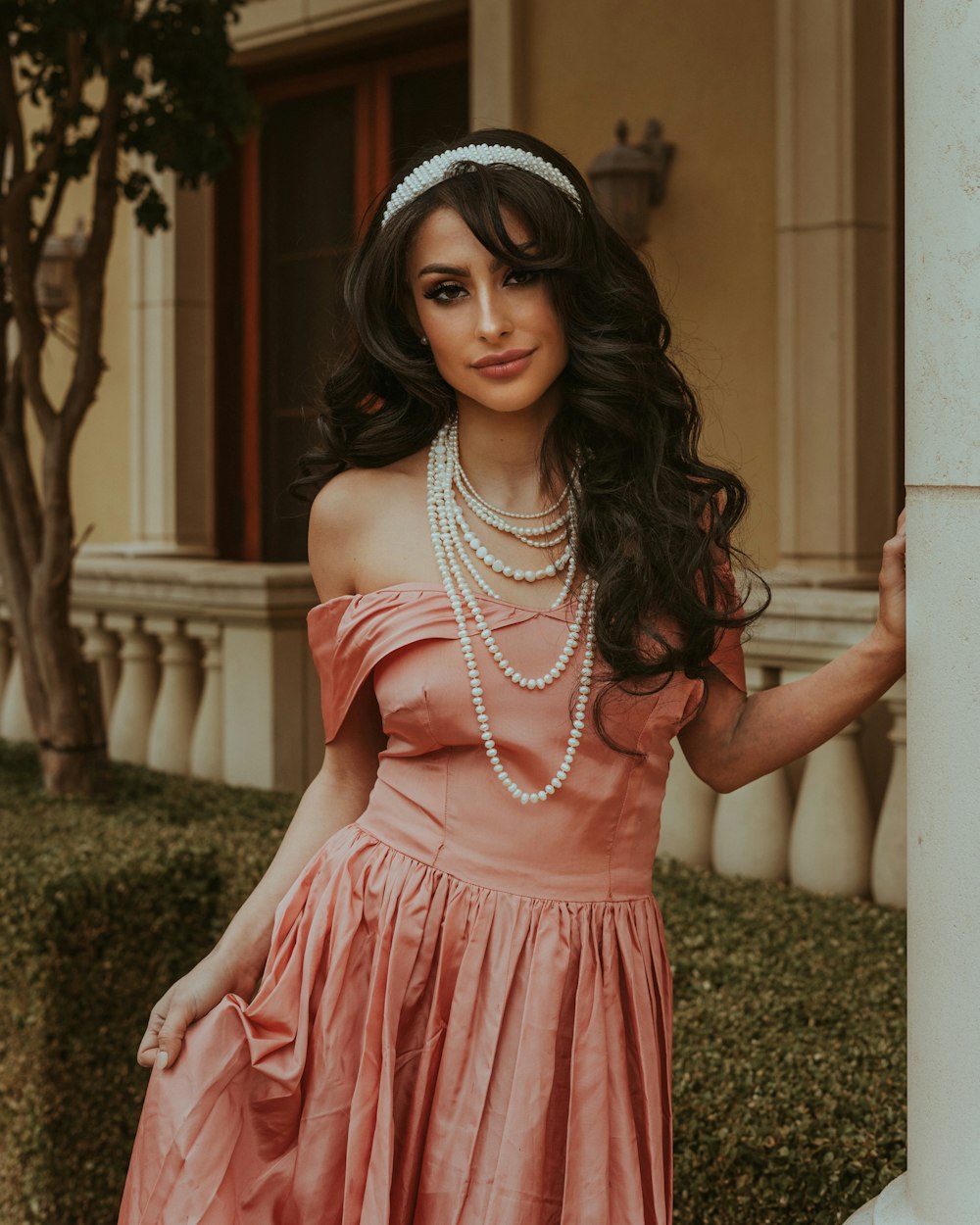 a woman in a pink dress posing for a picture