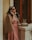 a woman in a pink dress talking on a phone