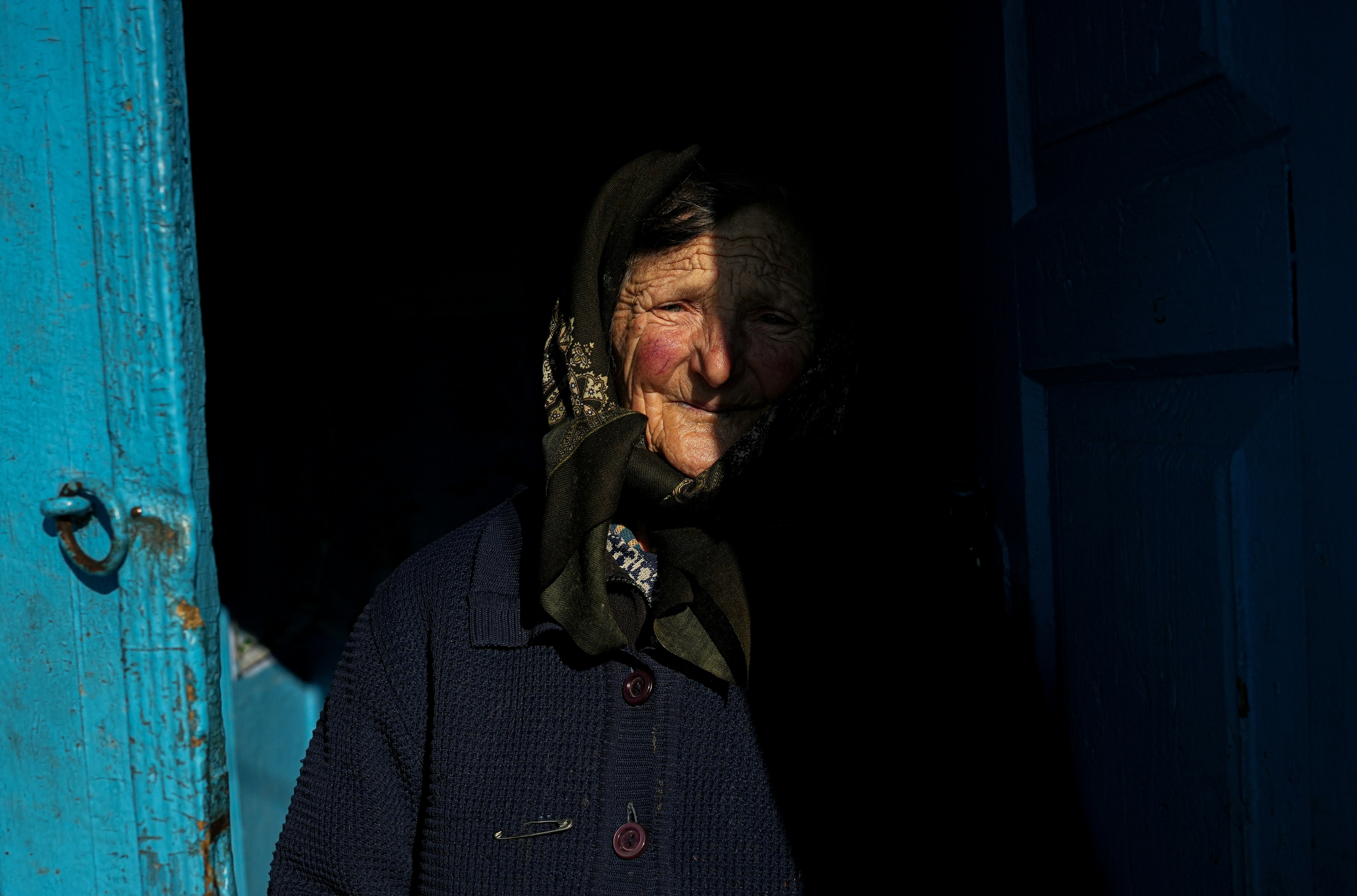 a man standing in a doorway with a scarf on his head