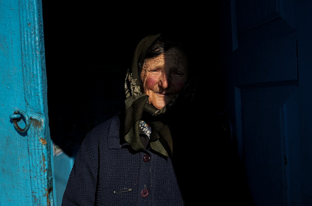 a man standing in a doorway with a scarf on his head