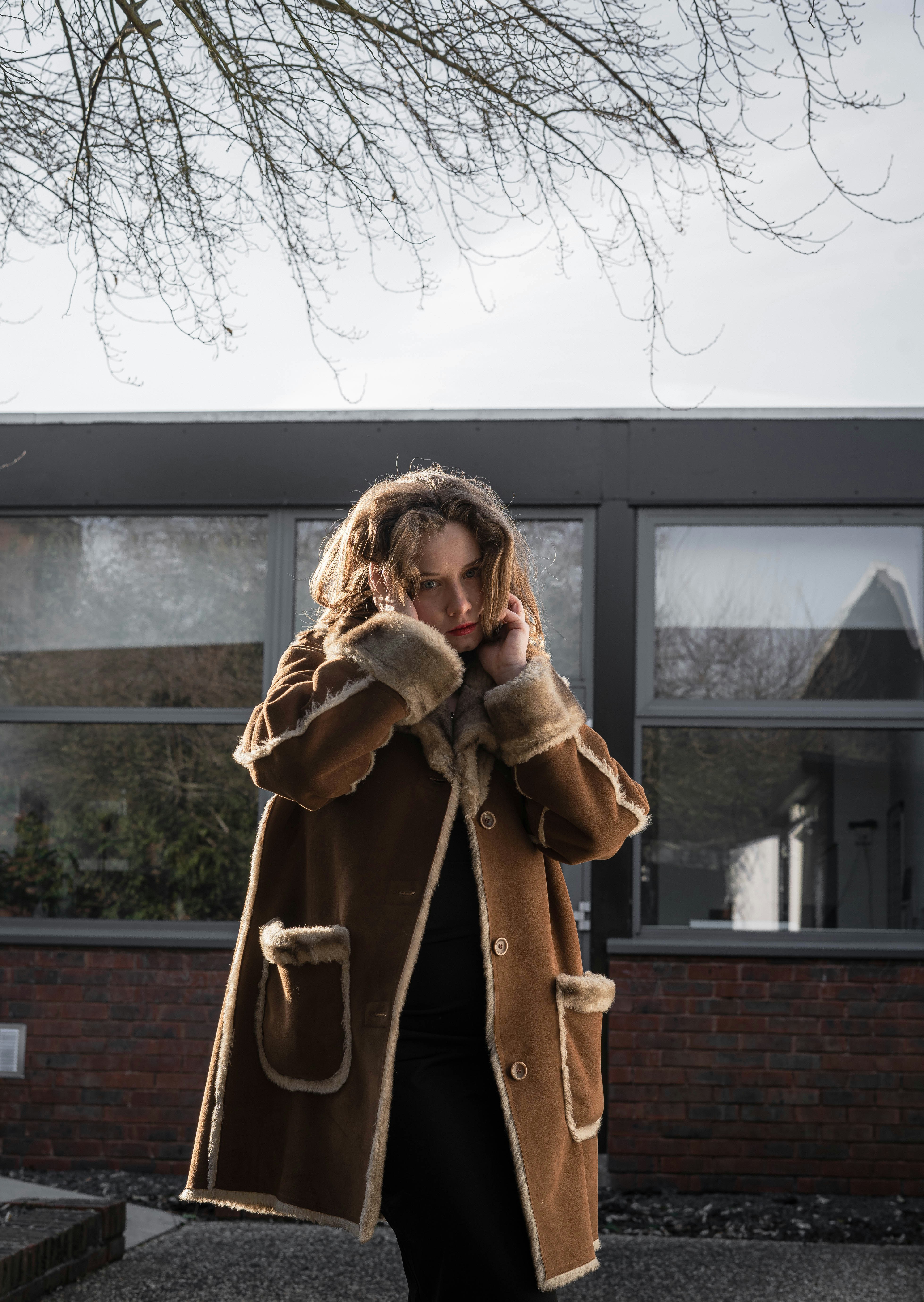 a woman walking down a street while talking on a cell phone