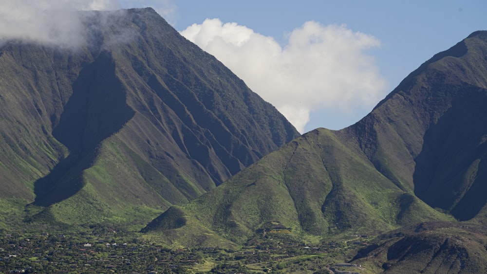 a mountain range with a village in the foreground