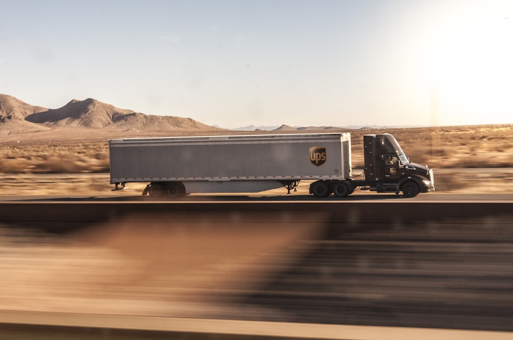 a truck driving down the road in the desert