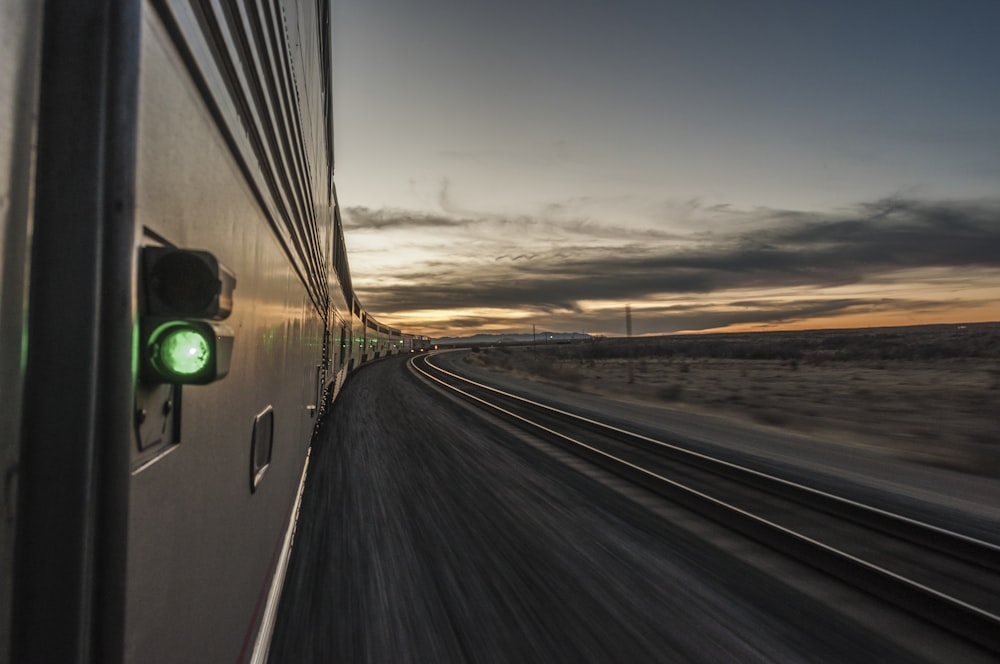 a train traveling down a train track at sunset