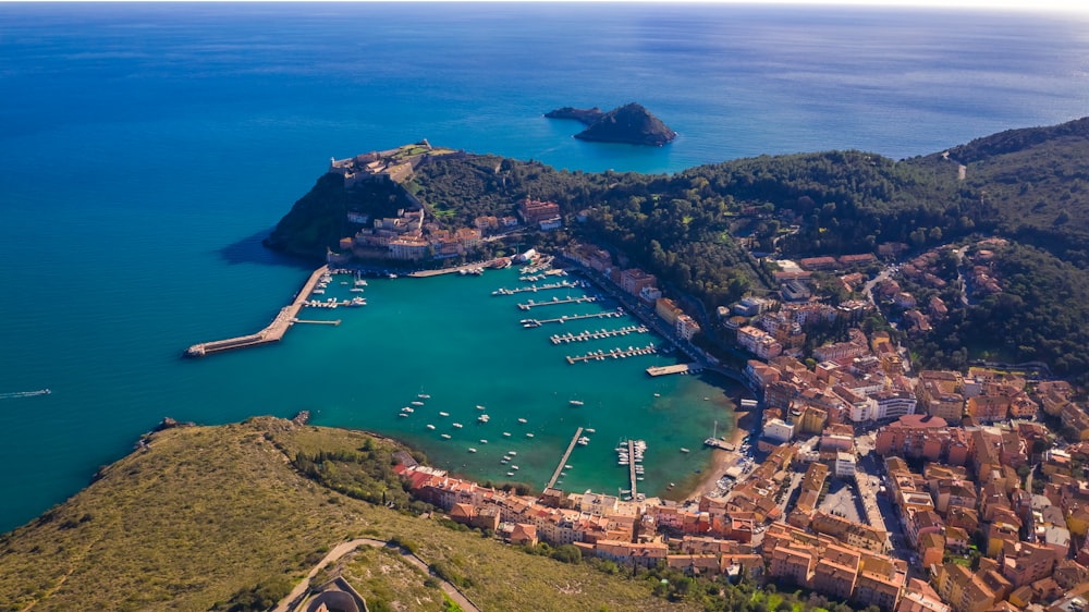 an aerial view of a harbor with boats in the water