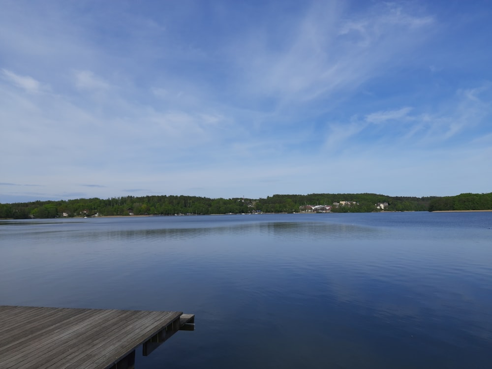 a wooden dock sitting on top of a lake