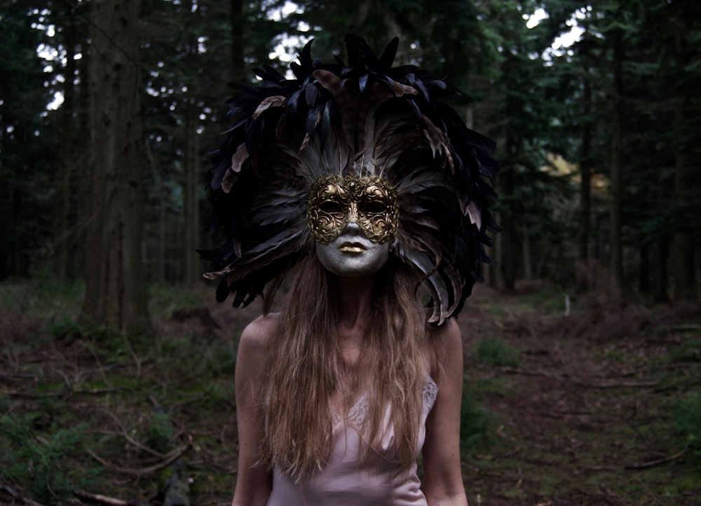 a woman wearing a mask in a forest