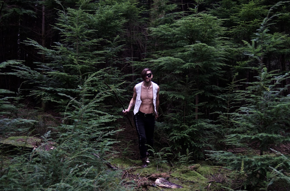 a man standing in the middle of a forest