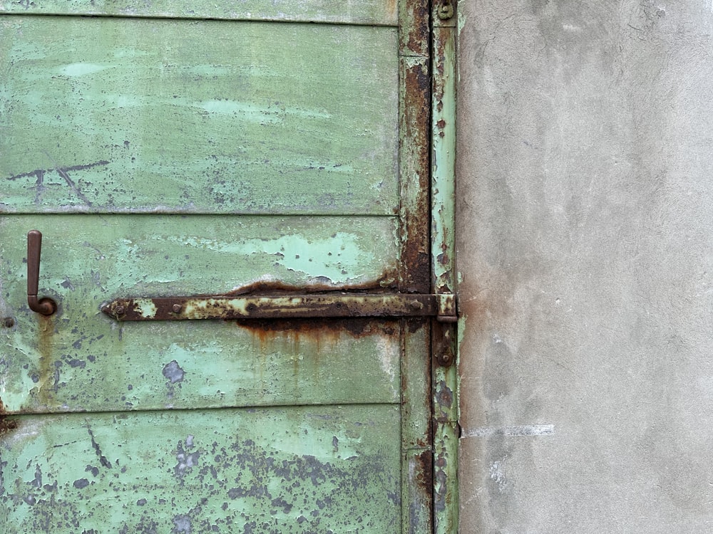 an old door with a rusted handle on it