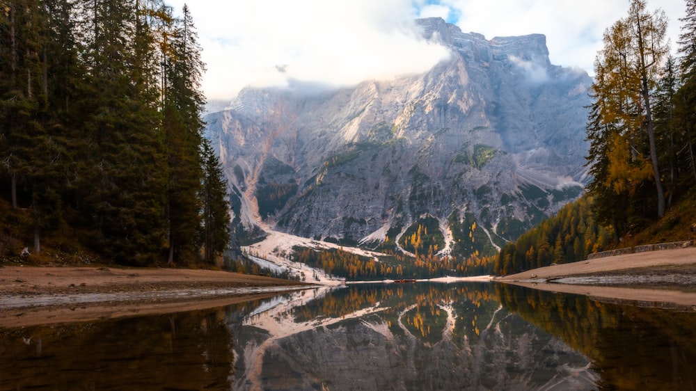 a mountain is reflected in the still water of a lake