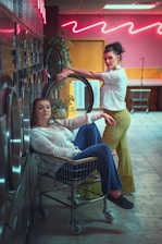 a woman pushing a shopping cart next to another woman