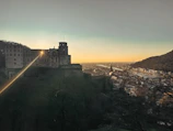 Fantasy adventure game showing a hero standing before a glowing castle at sunset.
