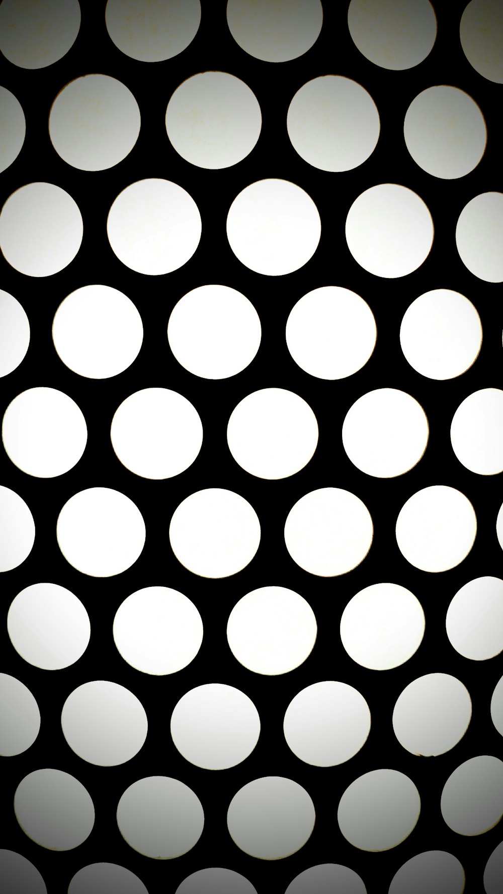 a black and white photo of a pattern of circles