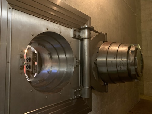 An open steel door revealing a well-lit, secure interior space.
