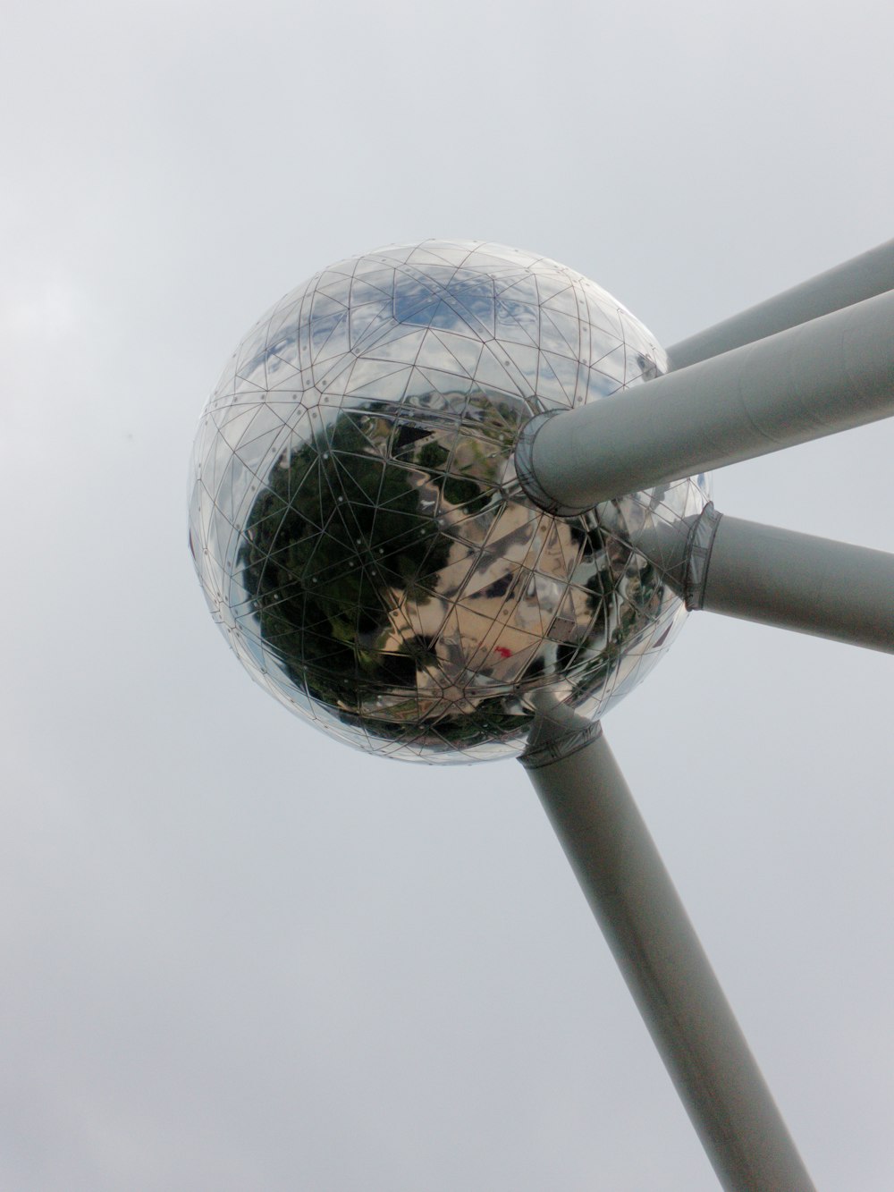 a reflection of a building in a mirror ball