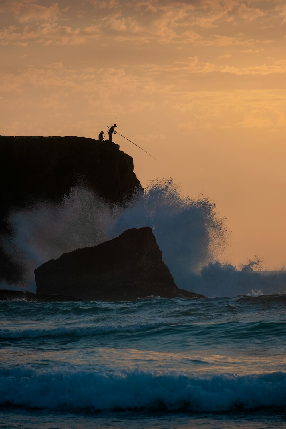 a man riding a wave on top of a surfboard